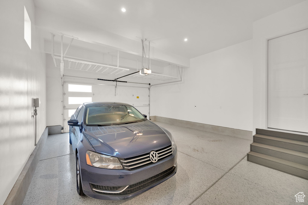 Garage with a garage door opener and recessed lighting