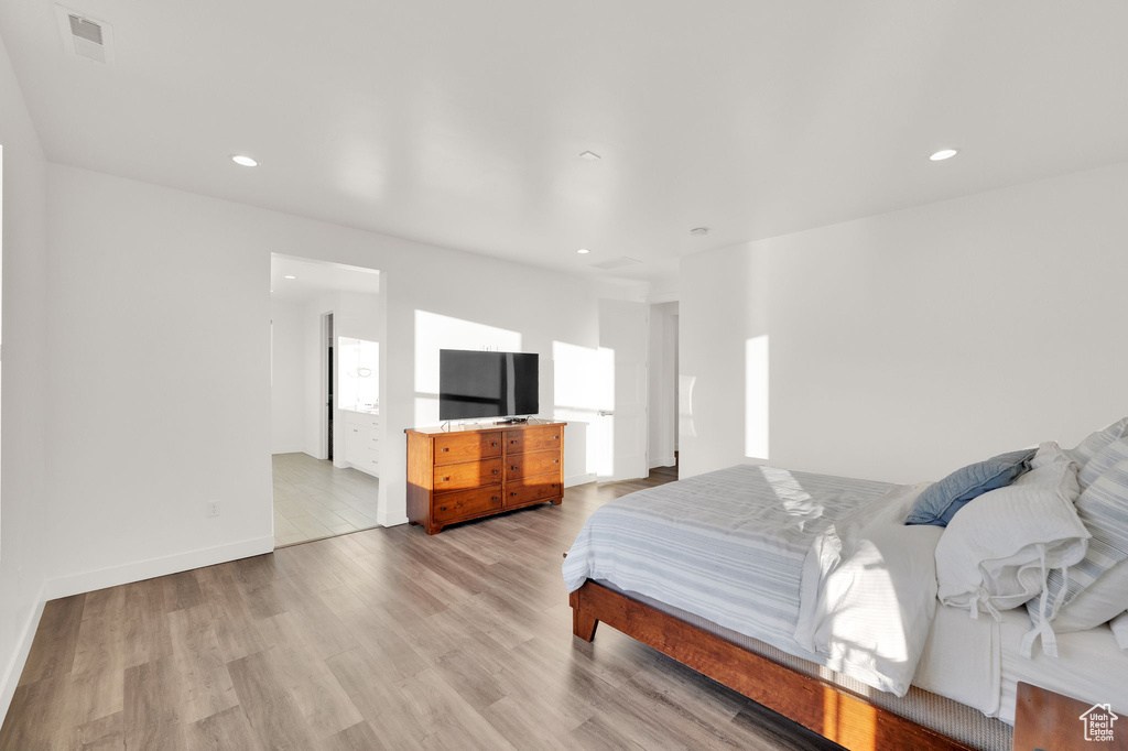 Bedroom with light wood finished floors and recessed lighting