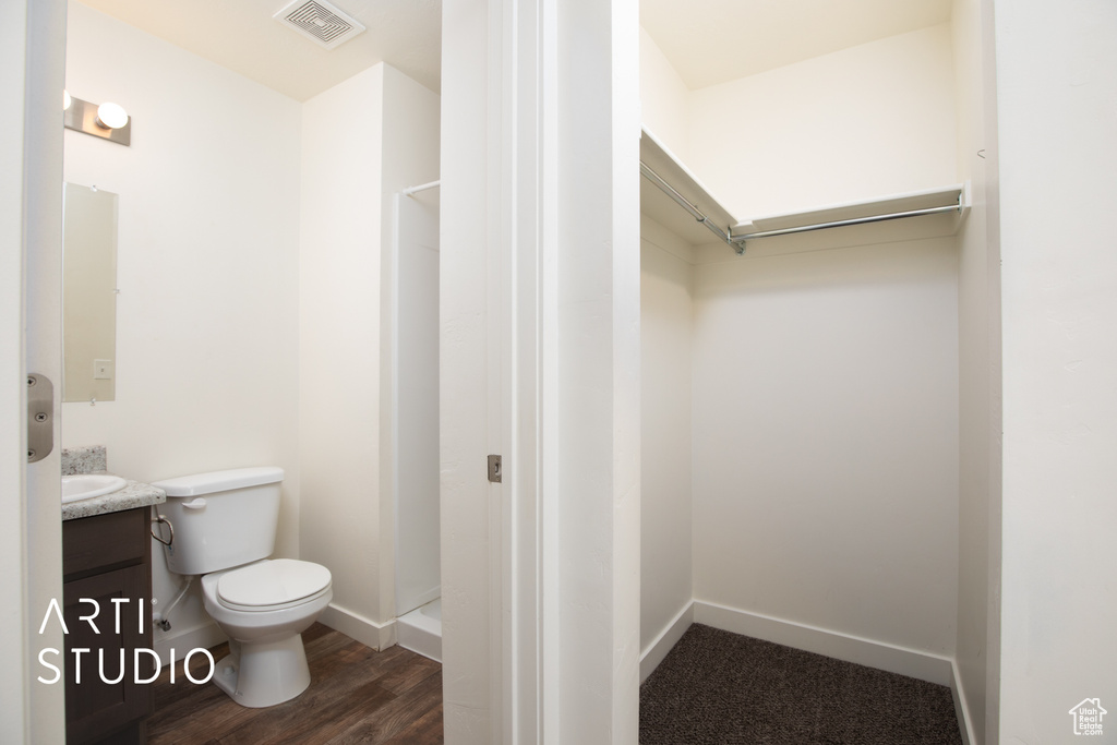 Full bathroom with vanity, a shower, and wood finished floors
