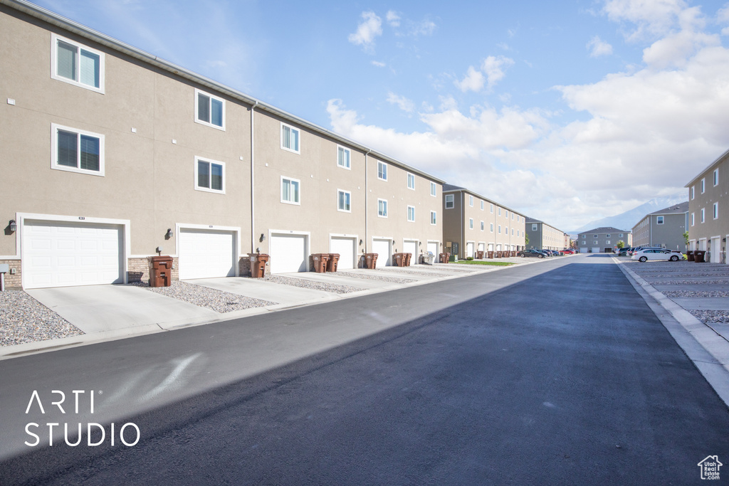 View of asphalt street featuring a residential view
