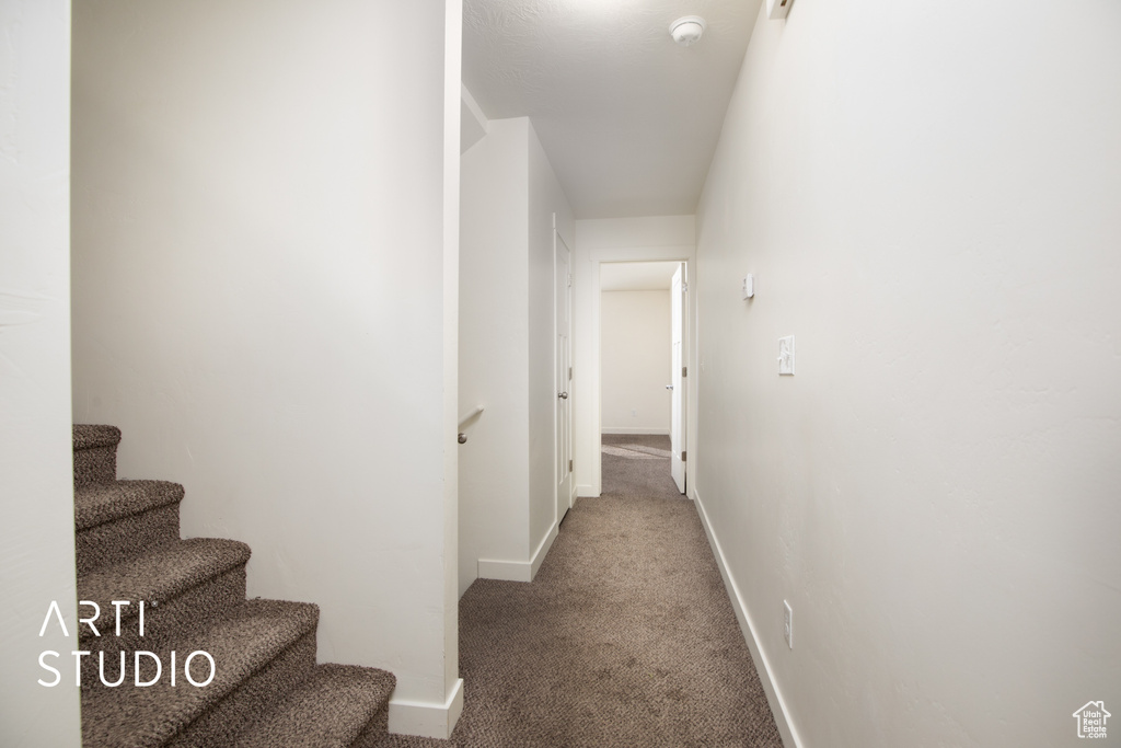 Hall with carpet floors and stairway