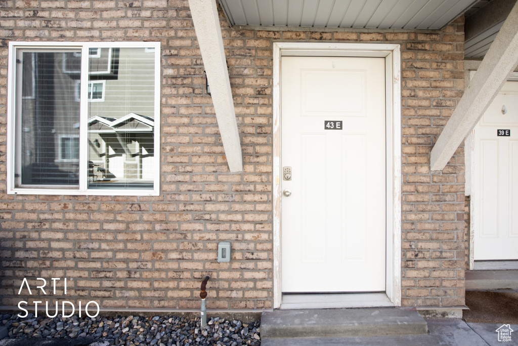 Doorway to property with brick siding
