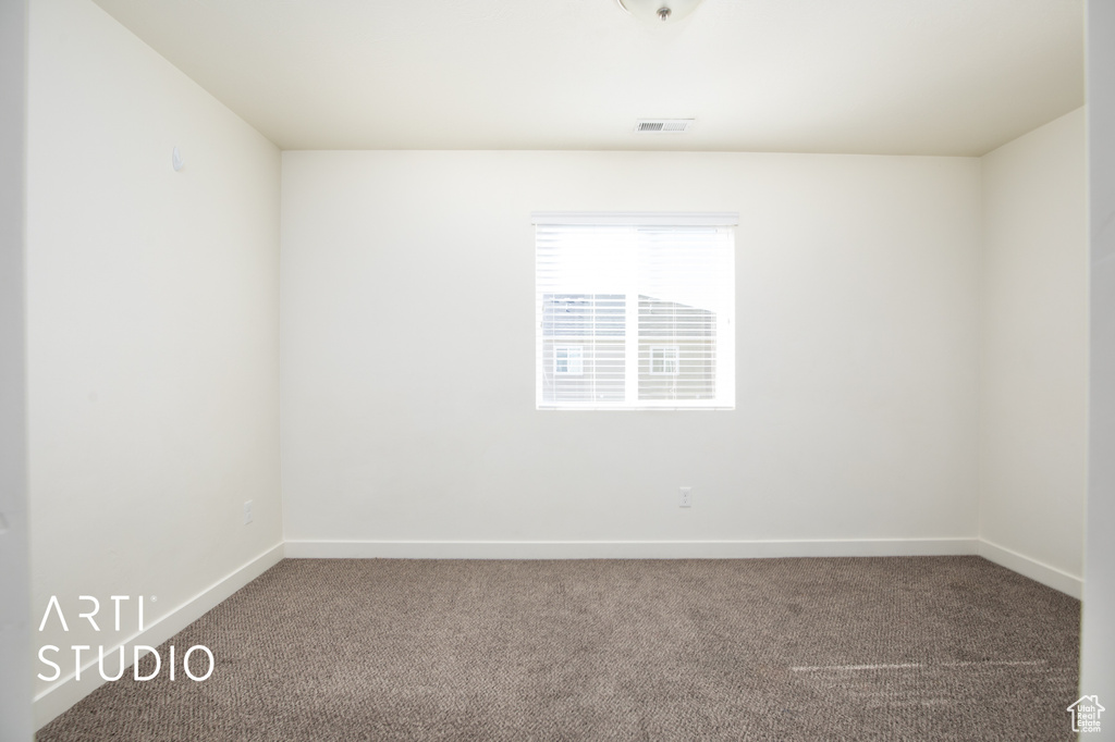 Unfurnished room with carpet and baseboards