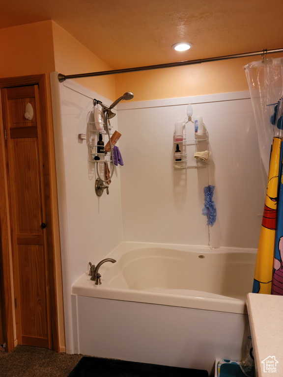 Full bathroom with shower / tub combo with curtain