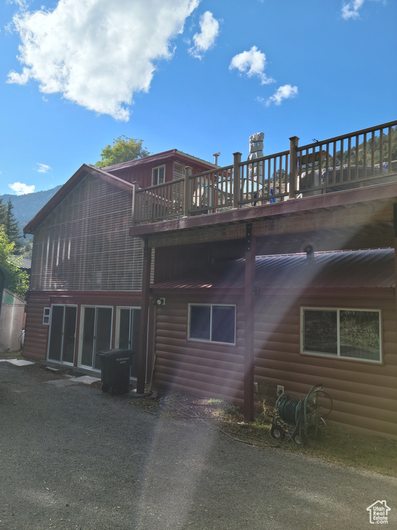 Rear view of house with faux log siding