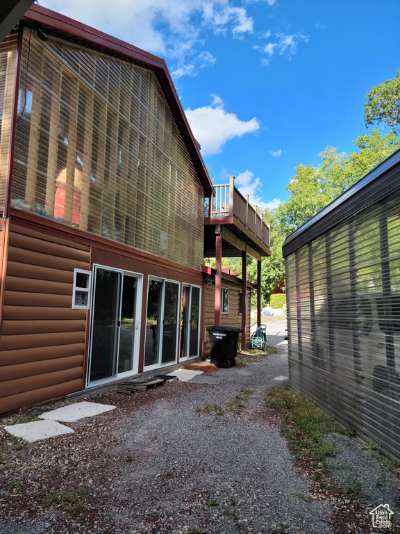 Rear view of house with faux log siding and a wooden deck