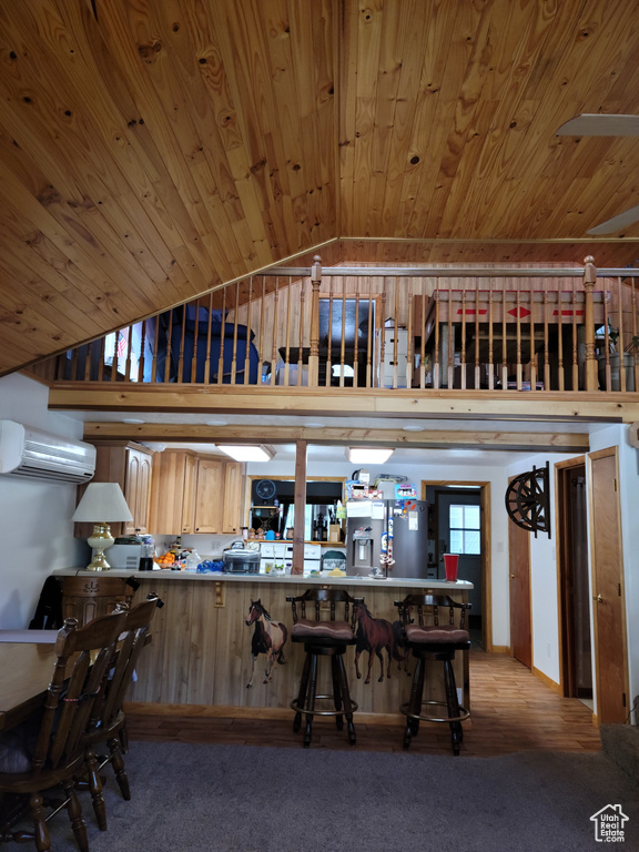 Kitchen featuring a wall mounted AC, lofted ceiling, wood ceiling, stainless steel fridge, and carpet