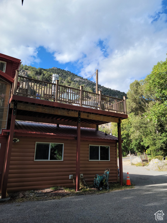 View of home\'s exterior with log veneer siding and a deck