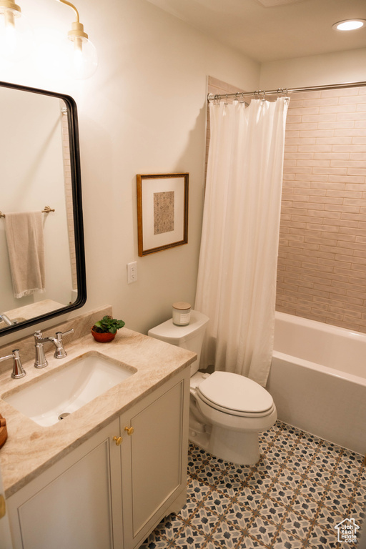 Bathroom featuring vanity, shower / bathtub combination with curtain, recessed lighting, and tile patterned floors