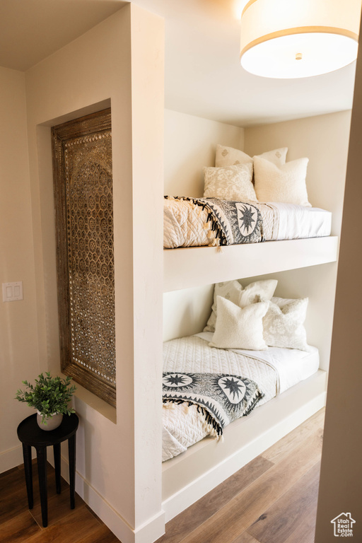 Bedroom featuring wood finished floors and baseboards