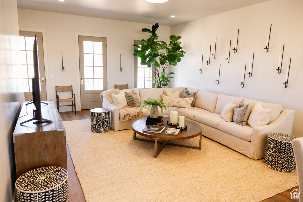 Living area featuring wood finished floors and recessed lighting