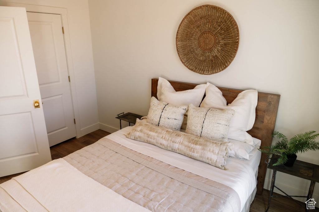 Bedroom with wood finished floors and baseboards