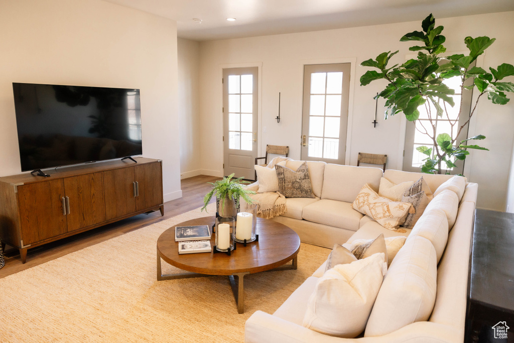 Living room featuring light wood-type flooring and recessed lighting
