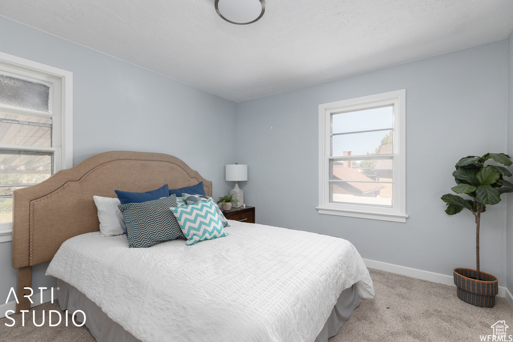Carpeted bedroom featuring baseboards