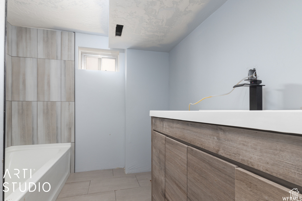 Full bath with tile patterned floors and vanity