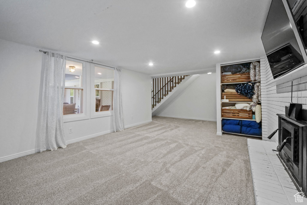 Below grade area featuring carpet flooring, stairs, and recessed lighting