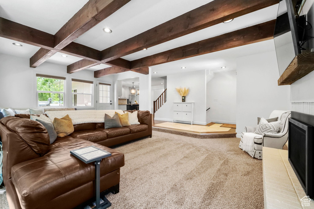 Living room with stairs, recessed lighting, carpet, and beam ceiling
