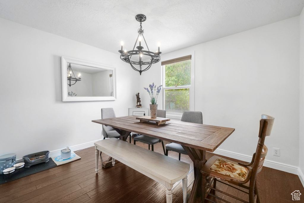 Dining space featuring a chandelier and wood finished floors