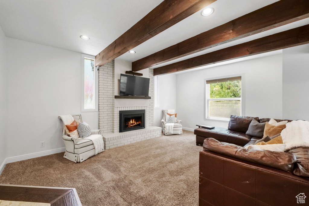Living room featuring carpet floors, a fireplace, beam ceiling, and recessed lighting
