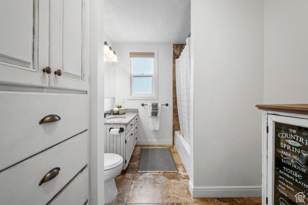 Bathroom featuring vanity and a textured ceiling
