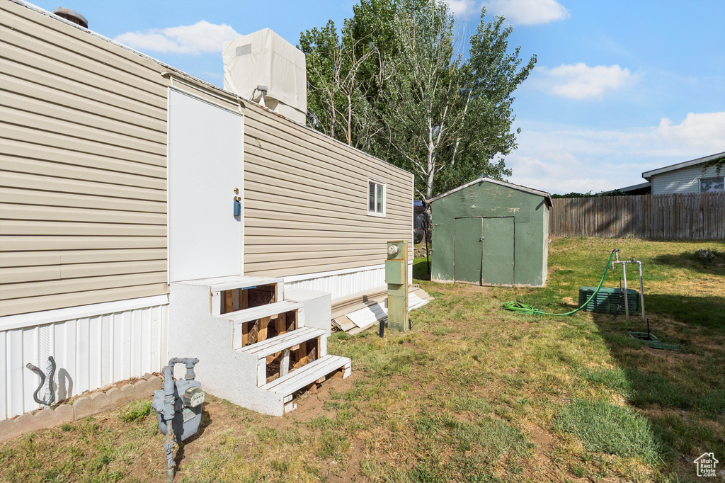 View of yard with a storage unit