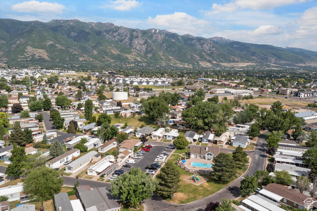 Aerial view of property's location with a mountain backdrop and nearby suburban area