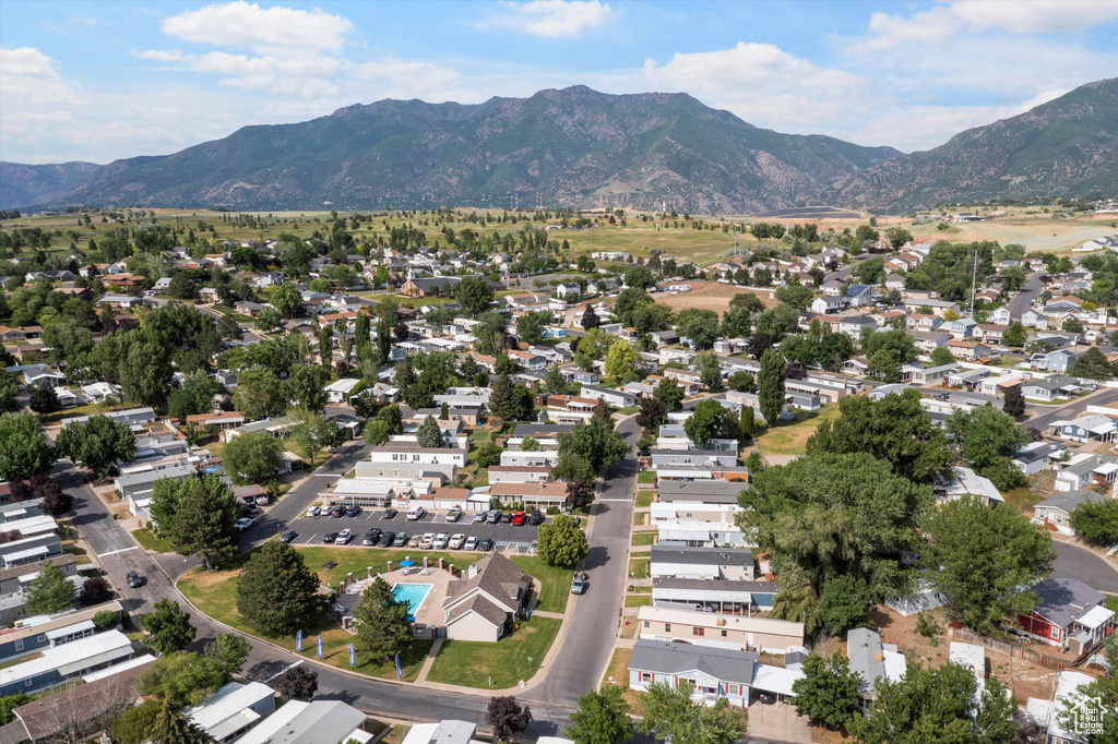 Aerial view of property and surrounding area with a mountainous background and nearby suburban area
