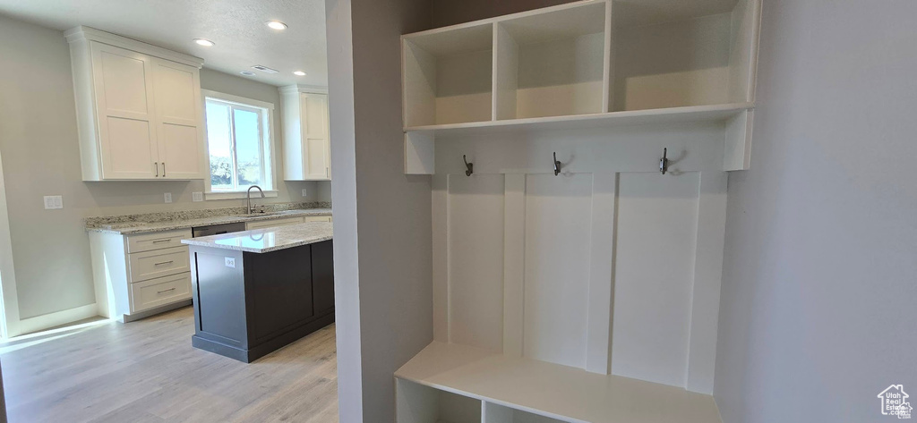 Mudroom featuring light wood finished floors and recessed lighting