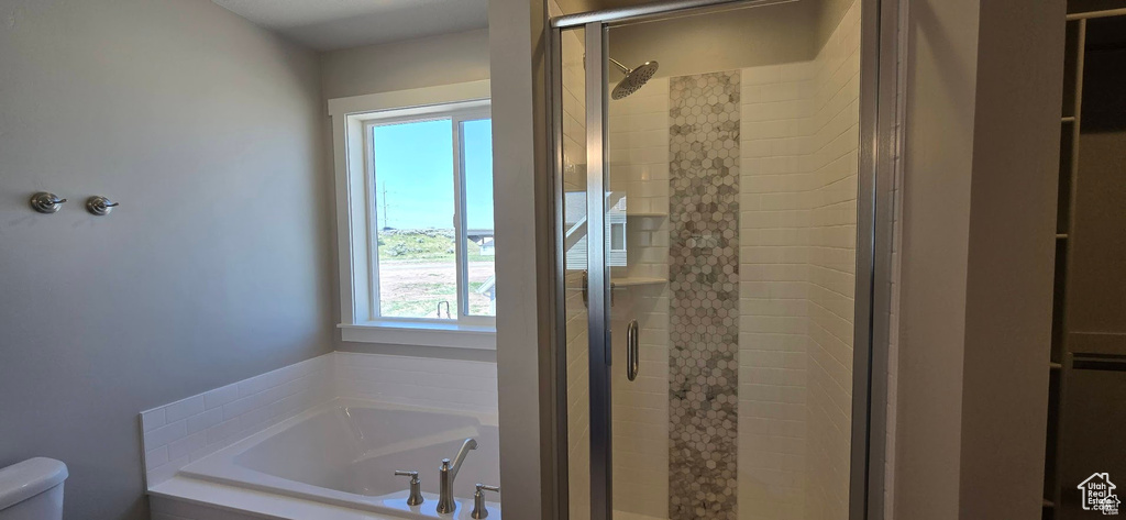 Full bathroom featuring a shower stall and a bath