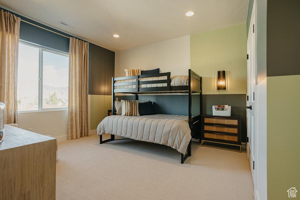 Carpeted bedroom with multiple windows and recessed lighting