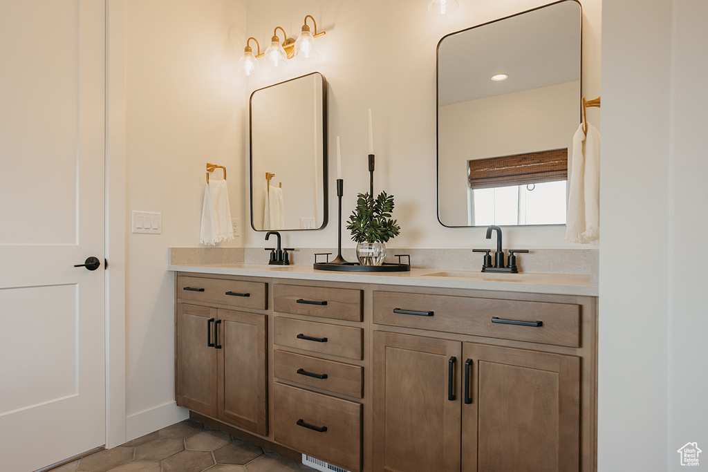 Bathroom with double vanity and tile patterned floors