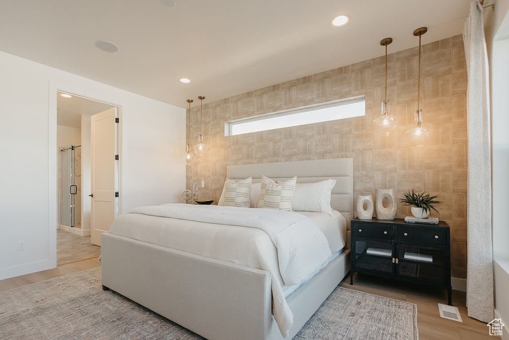 Bedroom with wood finished floors and recessed lighting