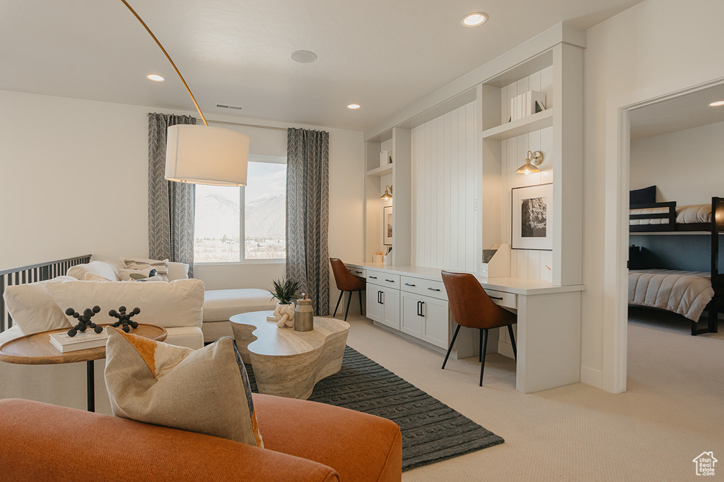 Living room with light carpet and recessed lighting