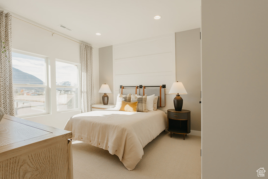 Bedroom featuring light colored carpet and recessed lighting