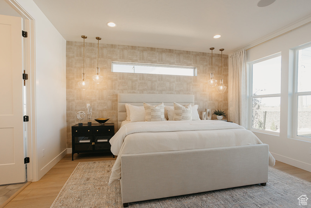 Bedroom with multiple windows, recessed lighting, and light wood-style flooring
