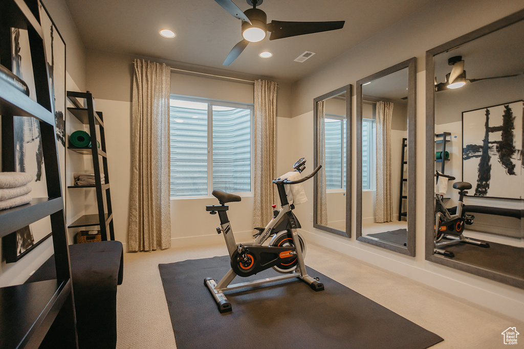 Workout room featuring ceiling fan and recessed lighting