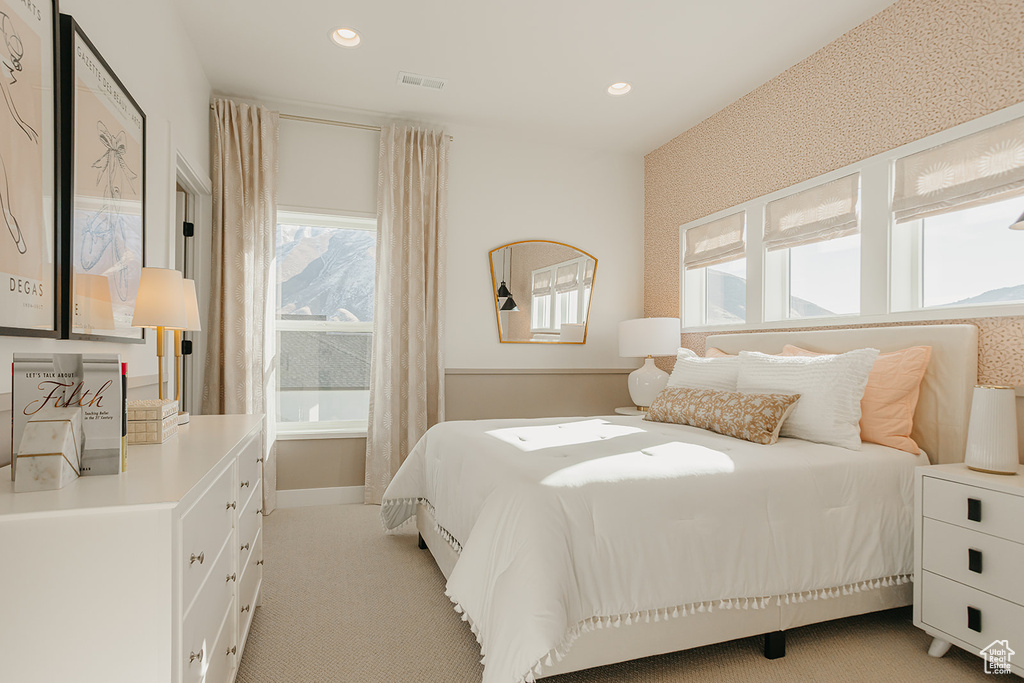 Bedroom featuring light carpet and recessed lighting