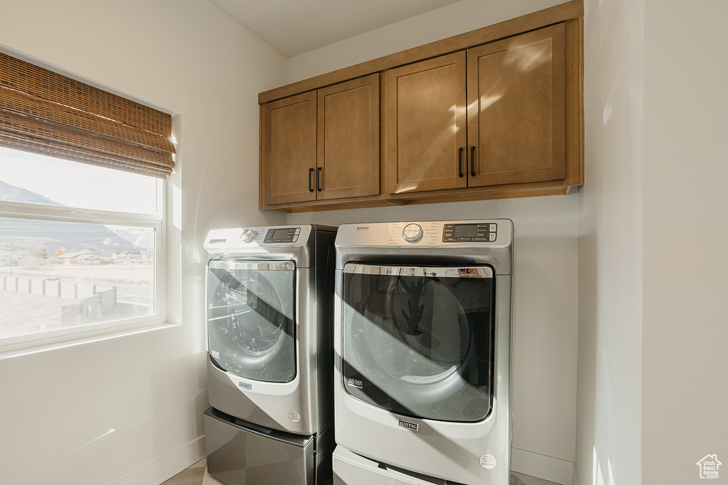 Laundry room with cabinet space and washing machine and clothes dryer