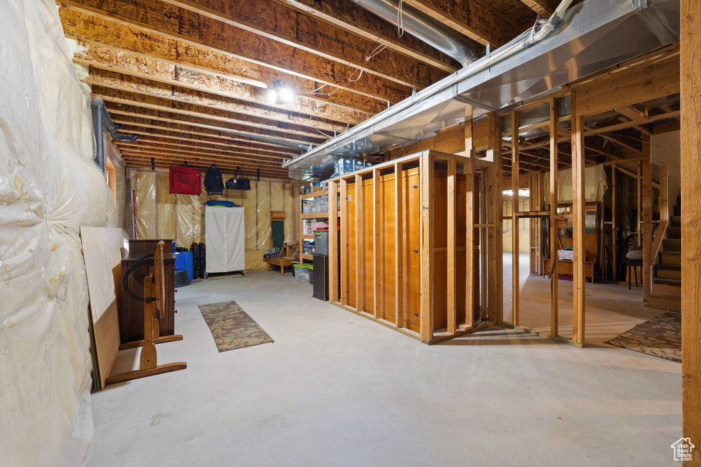 Unfinished below grade area featuring stairway