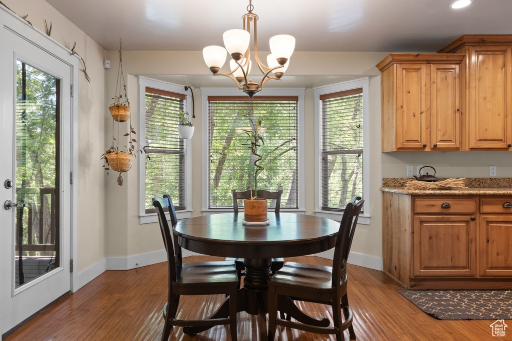 Dining space featuring wood finished floors, a chandelier, and recessed lighting