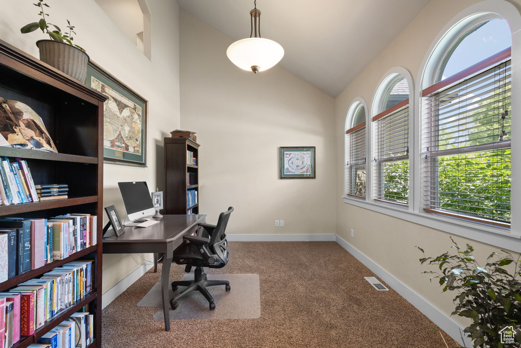 Carpeted office featuring lofted ceiling and baseboards