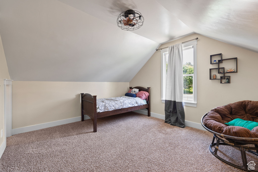 Bedroom with lofted ceiling and carpet floors
