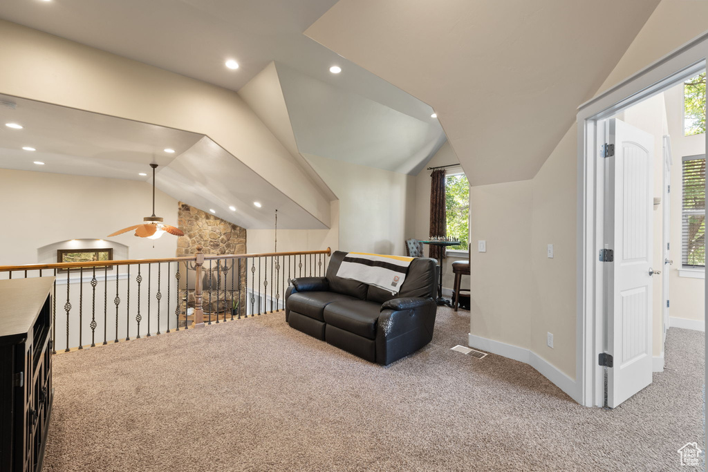 Living area featuring carpet floors, ceiling fan, lofted ceiling, and recessed lighting