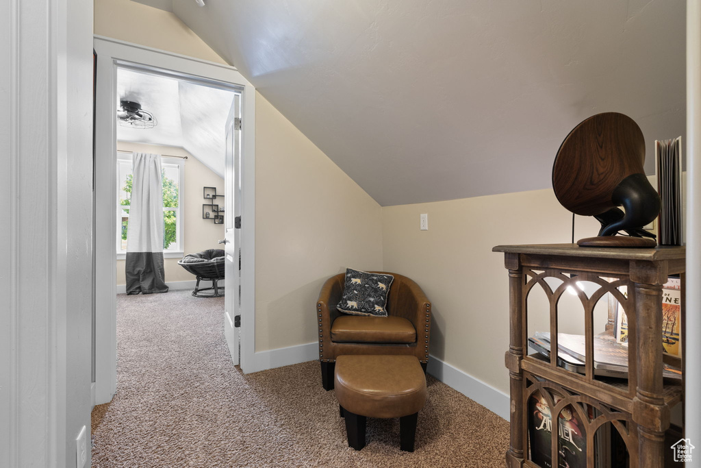 Sitting room with vaulted ceiling and carpet floors