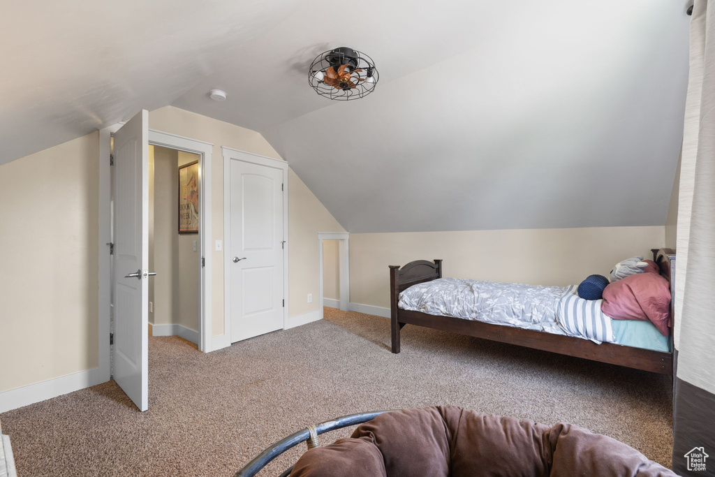 Bedroom with carpet and lofted ceiling