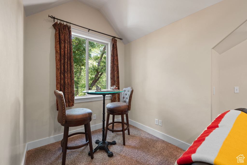 Office space with vaulted ceiling and carpet