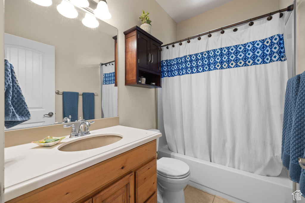 Full bath with vanity, shower / bath combination with curtain, and tile patterned flooring