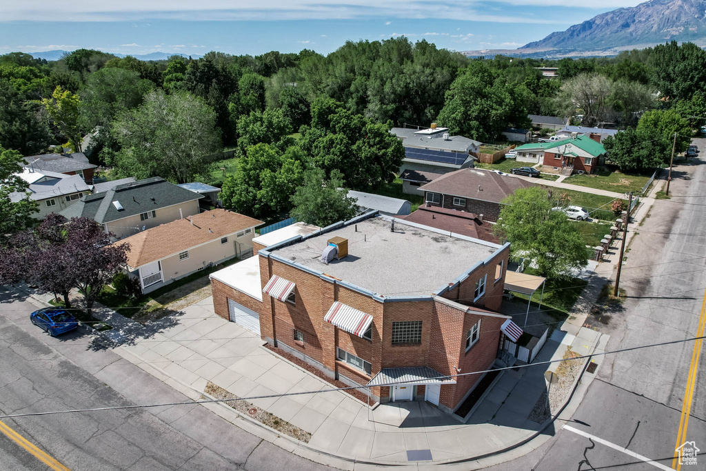 Aerial view of property and surrounding area featuring a mountainous background