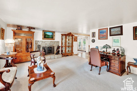 Carpeted living room featuring a fireplace
