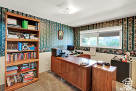 Office space featuring wallpapered walls